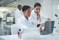 6 Steps To Help You Choose The Right Clinical Trial Partner laboratory scientist laptop GettyImages-1302454417