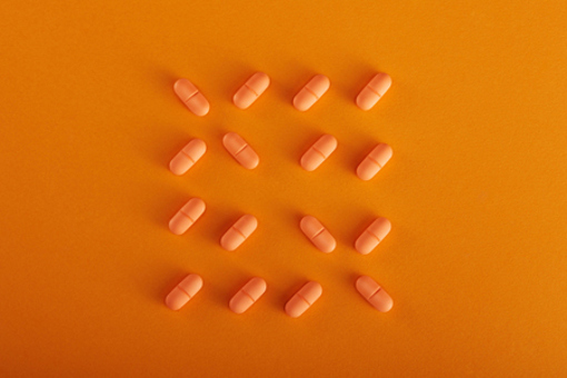 Orange Pills-GettyImages-1404554795