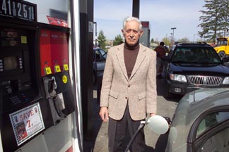 Ecologist David Pimentel, shown here pumping gas, says that his analysis shows that producing ethanol uses more energy than the resulting fuel generates. Copyright© Cornell University. (Photo credit: Chris Hallman/University Photography)