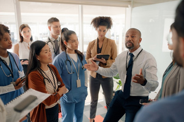 hospital boardroom discussion-GettyImages-2148736113