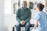 Man with nurse in clinic-GettyImages-2244535535