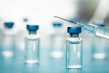 Vaccine injectable vials and syringe GettyImages-1252804942