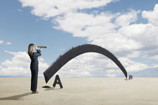 Businesswoman looks through spyglass-GettyImages-931159668