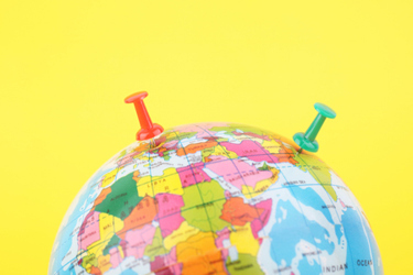 World globe with pushpins-GettyImages-1289685049 World globe with pushpins-GettyImages-1289685049