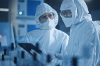 Environmental Monitoring Vs. Good Aseptic Technique GettyImages-1294339667-scientists-protective-gear-tablet-teamwork