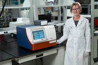 Scientist standing with SpectraMax iD5e mutlt-mode microplate reader gas mixer included