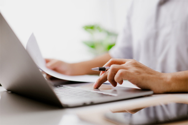 GettyImages-1348546519-laptop-pen-hand-laptop-review-documents GettyImages-1348546519-laptop-pen-hand-laptop-review-documents