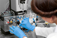 GettyImages-2258304529-scientist-with-vial-and-tubing-in-lab