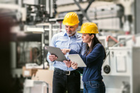 The Industrial DataOps Solution For Industry 4.0 GettyImages-968924932 Industrial engineers with tablet in a factory checking documents