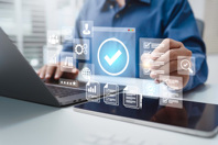 GettyImages-2200522087-computer-digital-validation-hand-with-pen