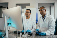 GettyImages-2166352840-scientists-in-lab-with-computer-screen