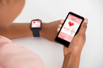 Hand With Mobile And Smartwatch Showing Heartbeat Rate-iStock-609624686