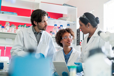 GettyImages-1094847564-scientists-laboratory-flasks-planning-tablet