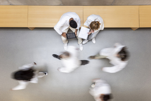 Scientists walking in corridor-GettyImages-1441665382