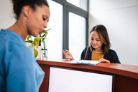 Woman checking in at a site reception desk 1 (high res)