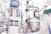 GettyImages-675822772-scientist-holding-book-with-bioreactor