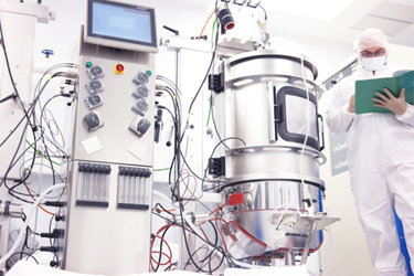 GettyImages-675822772-scientist-holding-book-with-bioreactor