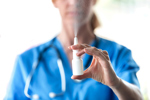 EMA Updates Guidance On Inhalation And Nasal Product Quality female doctor with nasal spray-GettyImages-1226391398