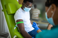 Man giving blood wearing mask-GettyImages-1340046608