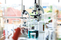 GettyImages-1133603364-lab-equipment-microscope-beaker-test tube