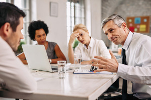 Angry businessman discussing with colleague-GettyImages-1133463611