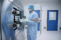 Operator loading nested vials into Microcell vial filler