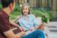 Mother and son or nurse talking outdoors (high res)