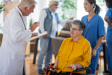 Doctor and patient in nursing home-GettyImages-1345138968