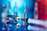 Vaccines and syringe in laboratory-GettyImages-1289691489