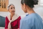 Female patient consults with an HCP during in-home visit (high res)