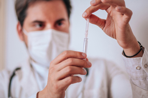 GettyImages-1340552087-syringe-mask-doctor-injection