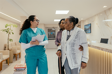 Grandmother-and-adult-granddaughter-speak-with-HCP-in-clinic-2-(high-res)-(1)