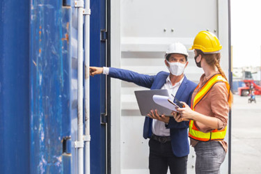 Teamwork-Forman-and-woman-wearing-safety-mask-iStock-1241151425 Teamwork-Forman-and-woman-wearing-safety-mask-iStock-1241151425