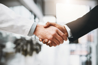 Reflecting On The Syneos Health Acquisition: The Due Diligence Imperative Doctor businessman shaking hands GettyImages-1098284154