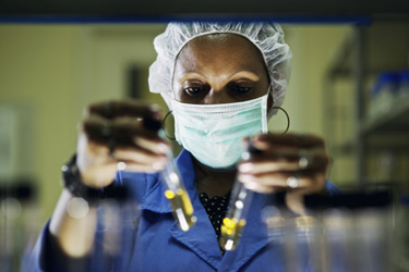Lab worker holding vials-GettyImages-178124875