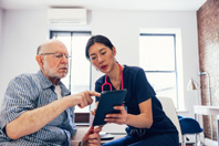Improving The Patient Experience In Clinical Research Nurse patient checking medical exams-GettyImages-1487540665