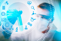 Biotech scientist looking at test tube 450x300