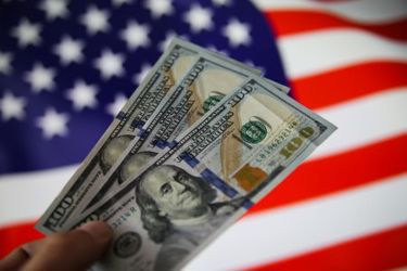 thumbnail_GettyImages-1257170796 money and flag