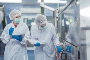 factory workers checking machines-GettyImages-1690936138