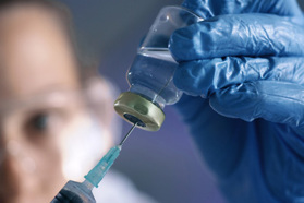 GettyImages-1413607446-vial-syringe-liquid-scientist-glove