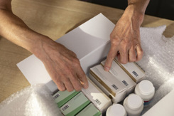 Hands holding medicine box-GettyImages-1474770915