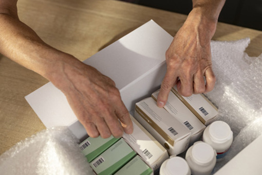 Hands holding medicine box-GettyImages-1474770915