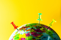 world globe with push pins-GettyImages-2227706894