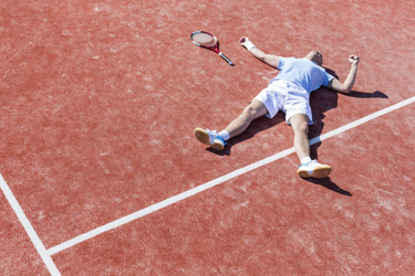 Man Lying On Tennis Court