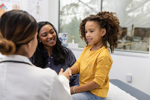 female doctor shakes hands with her young female patient-GettyImages-2123113270
