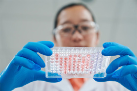 Continuous Flow — An Emerging Alternative GettyImages-1648451225 Scientist holding tray of samples in laboratory