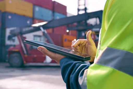 operator and tablet for shipping, cargo, inventory inspection, safe logistics-GettyImages-2167775964