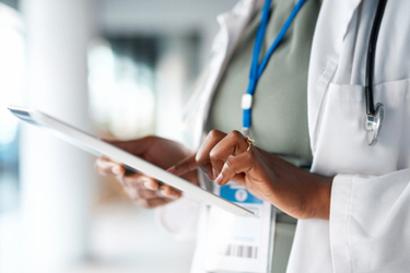 GettyImages-1468678613-doctor-setting-ipad-badge-hand GettyImages-1468678613-doctor-setting-ipad-badge-hand