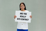GettyImages-2216539241-woman holding sign with text