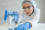GettyImages-1208573753-scientist-fizz-solubility-lab-glass
